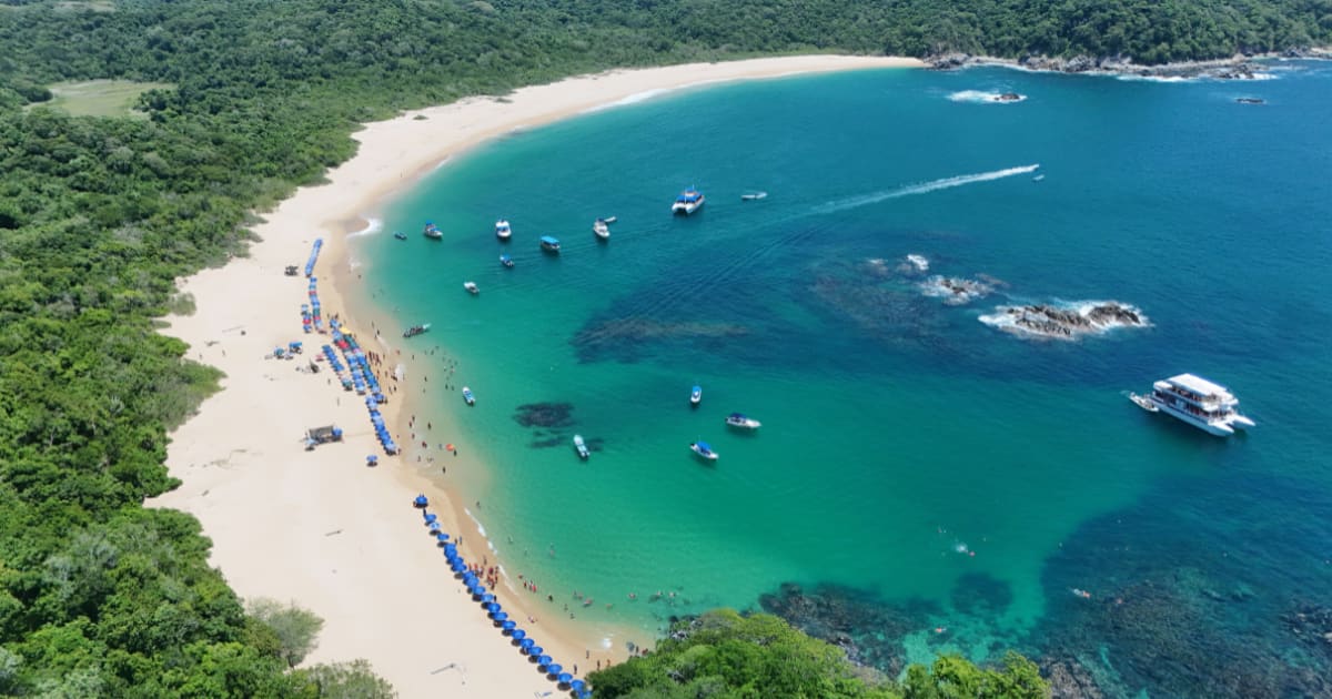 Aerial view of a turquoise bay in Huatulco with boats